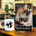 Paperback book cover of A Shadow's Kiss by Kirsten S. Blacketer with a romantic medieval couple embracing inside a stone castle.