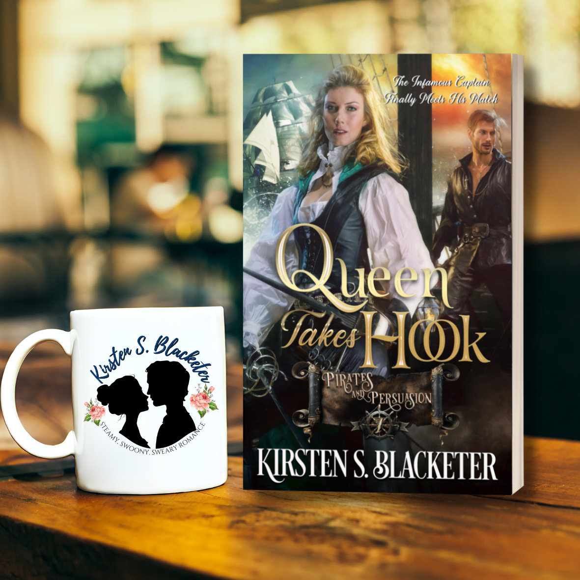 Book cover of Queen Takes Hook by Kirsten S. Blacketer featuring a woman with long blonde hair and a man in the background. Both on a pirate ship. Coffee mug with a logo of a couple and the name Kirsten S. Blacketer on it.