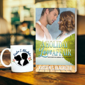 Paperback book A Holiday Love Affair by Kirsten S. Blacketer with couple facing each other and a lake and forest scene on cover. Coffee mug with a logo of a couple and the name Kirsten S. Blacketer on it.