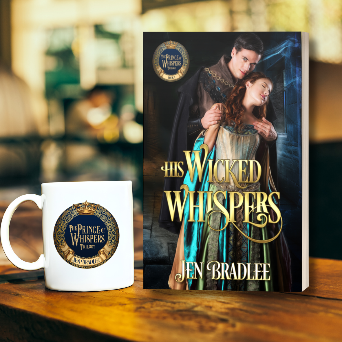 Paperback book titled His Wicked Whispers by Jen Bradlee with a medieval couple on cover next to matching white mug on wooden table.