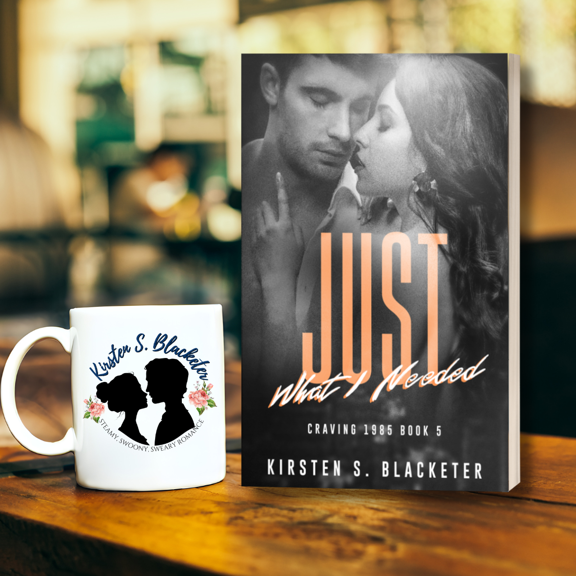 Romantic novel paperback with black-and-white couple and bold orange "Just What I Needed" title on cover.