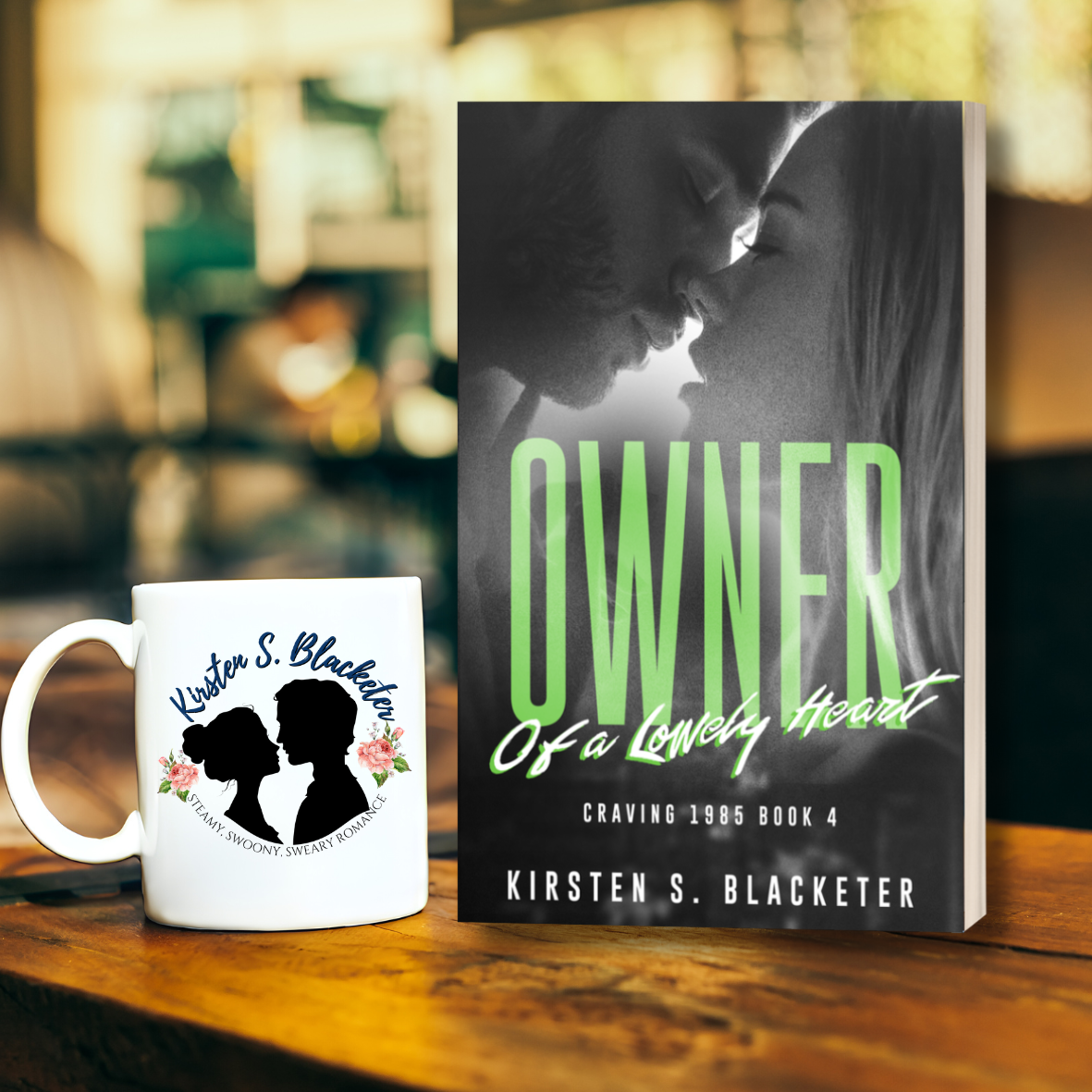 Paperback book titled "Owner of a Lonely Heart" with grayscale close-up of a couple touching foreheads, green and white text. 